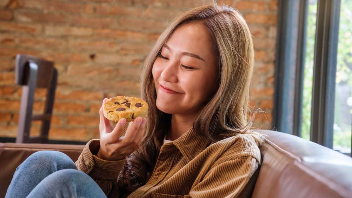 happy woman smiling at a cookie