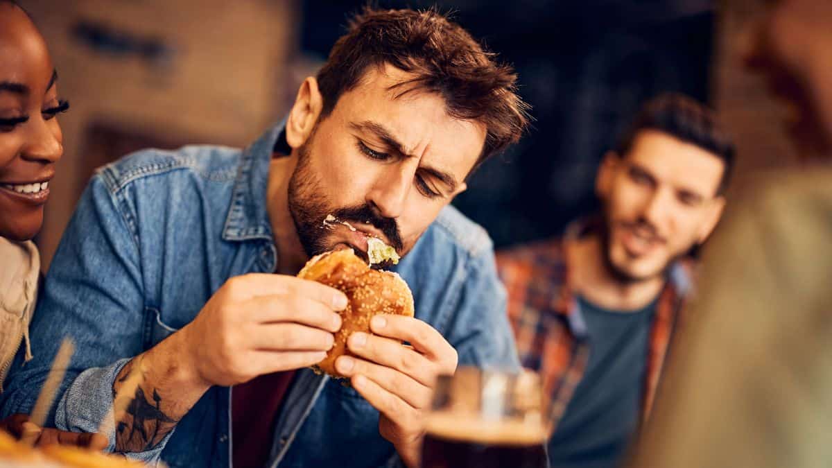 man eating burger