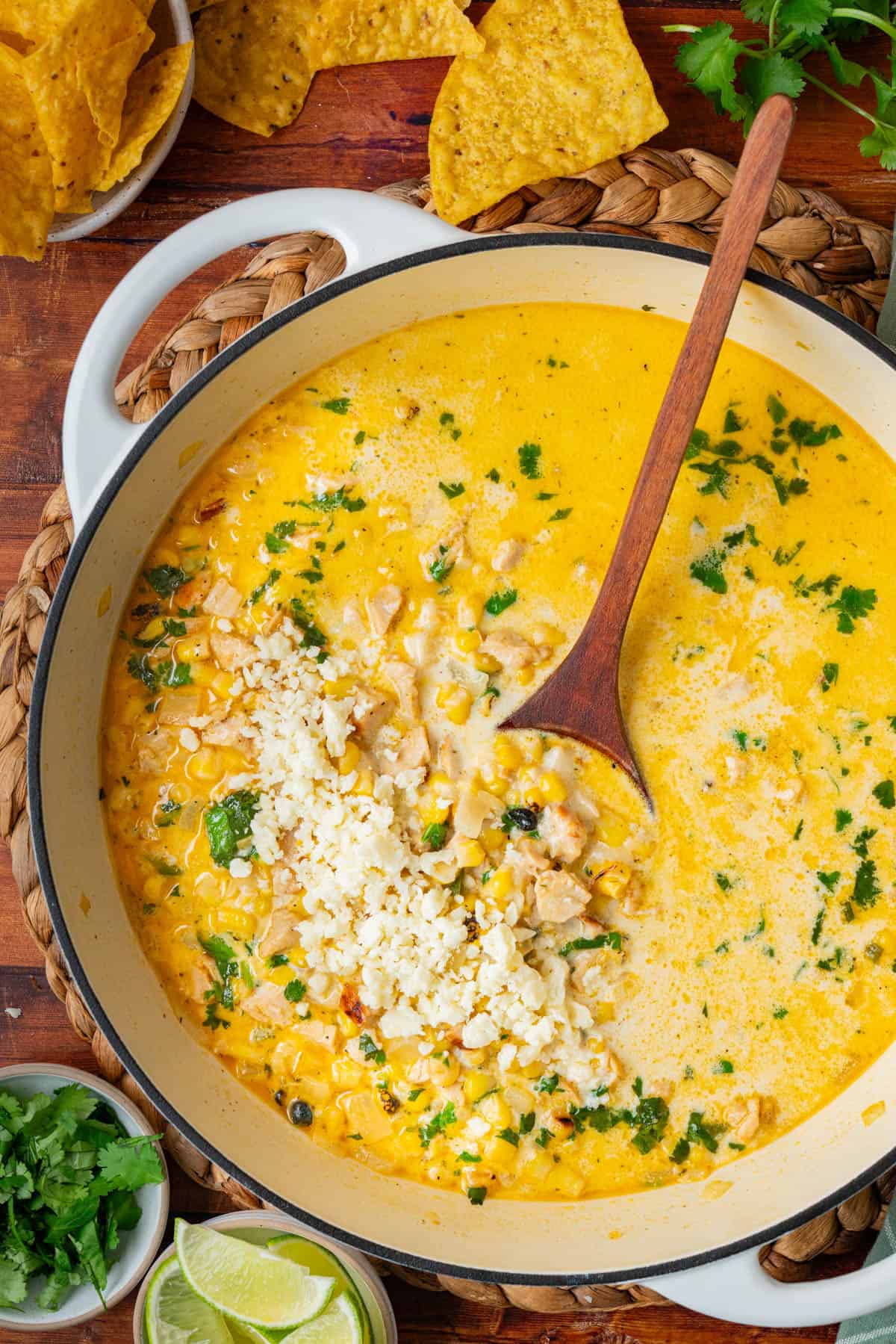 Overhead photo of the pot of street corn soup with a wooden spoon stirring