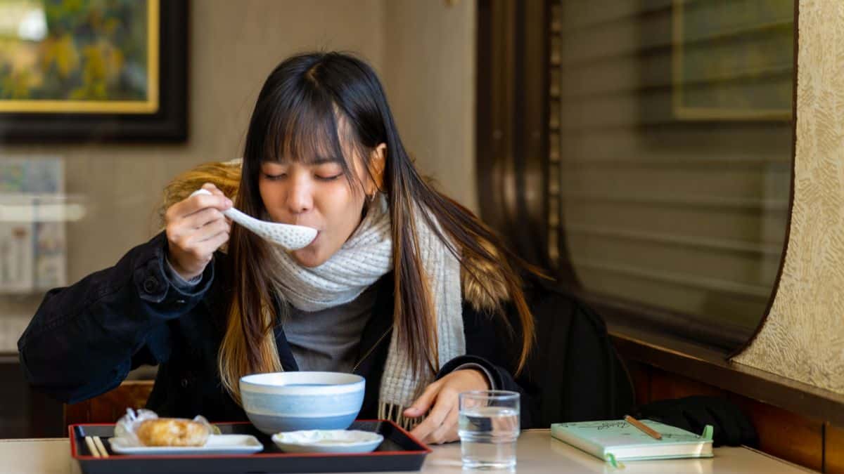 woman drinking soup