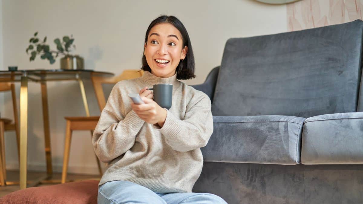 woman watching tv with coffee