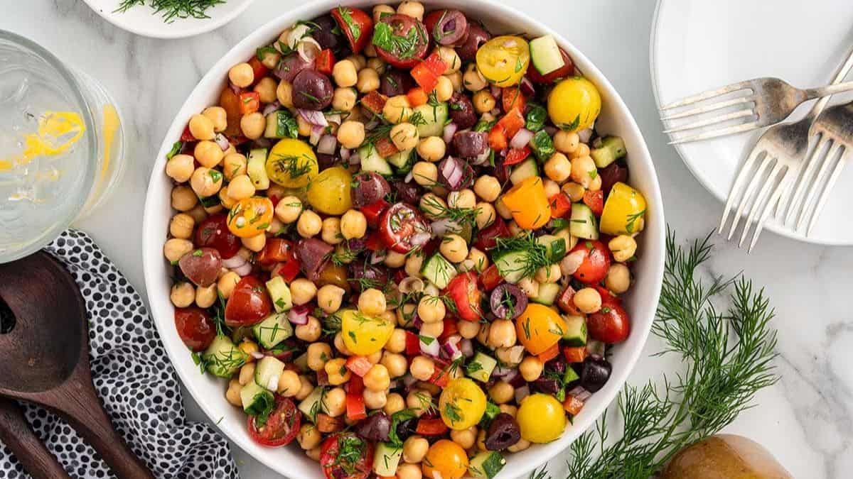 A top shot of a white bowl filled with Chickpea Salad.