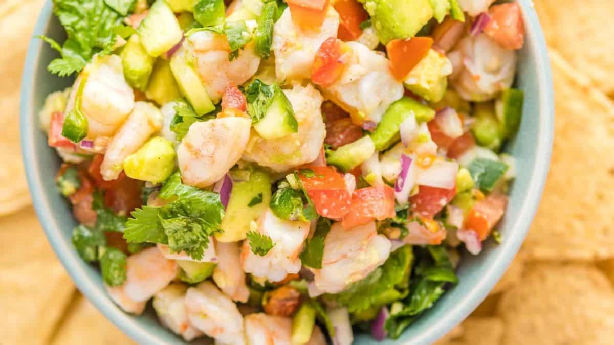 A bowl filled with Mexican-Style Shrimp Ceviche with nachos on the side.