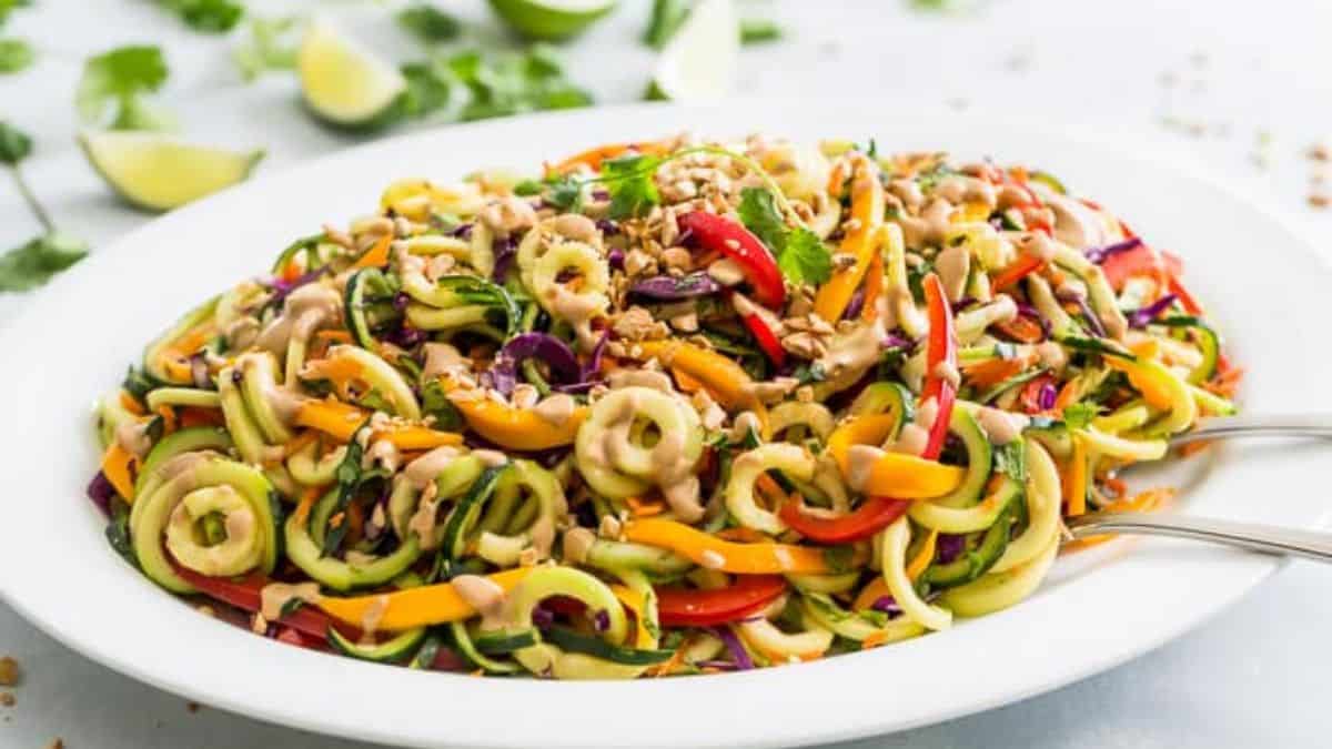 A serving platter filles with Rainbow Pad Thai Zucchini Noodle Salad. 