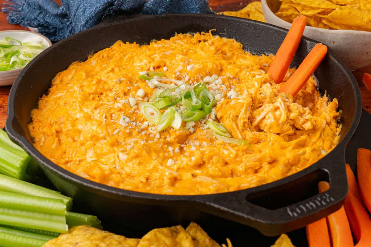 buffalo chicken dip with carrot sticks on the side.