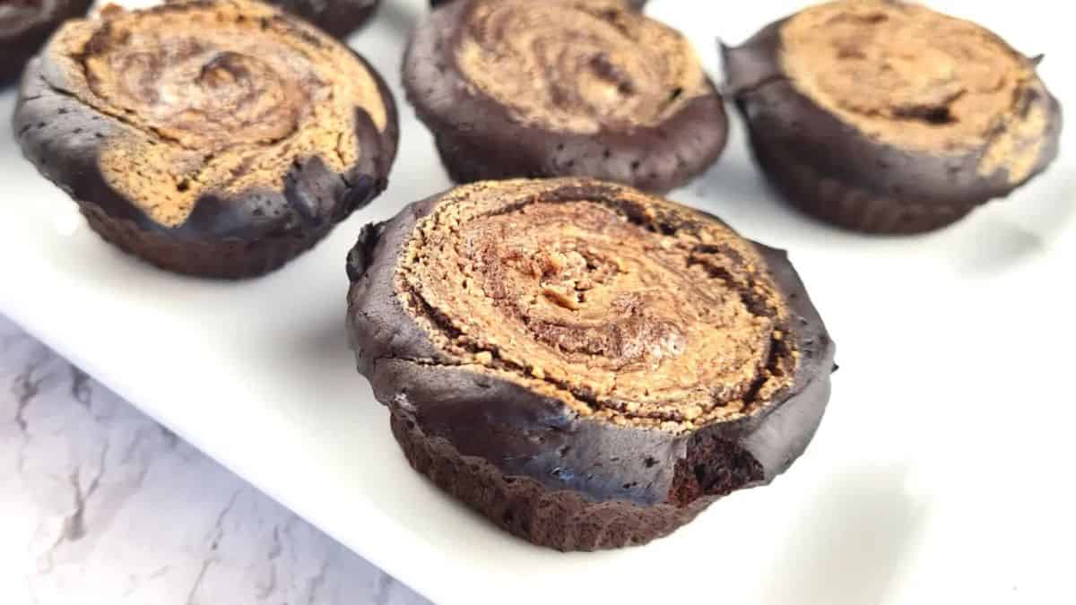 A couple of pieces of ChocoNut Bliss Keto Chocolate Peanut Butter Brownie Muffins.