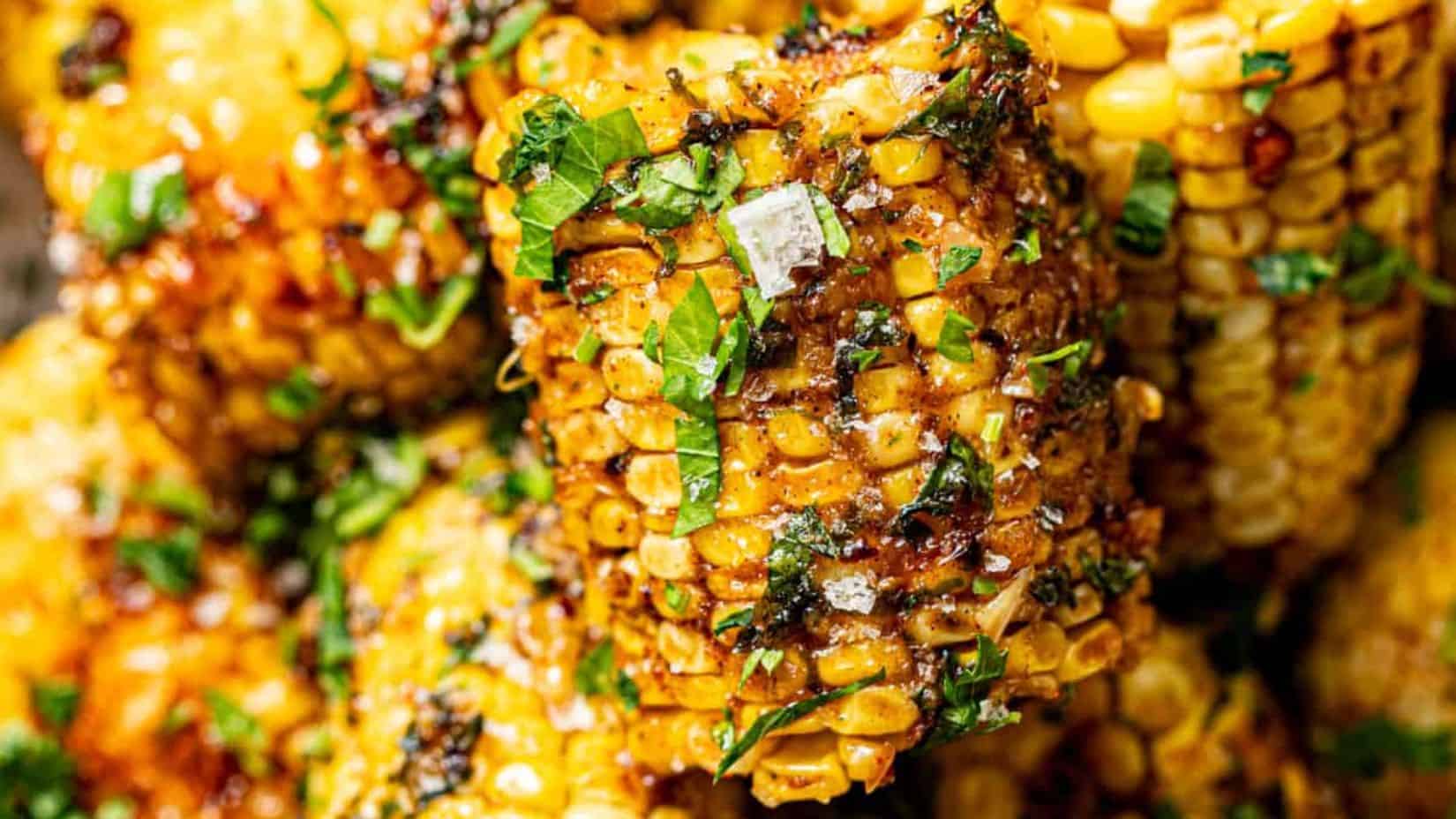 A close-up shot of a couple of pieces Cajun Corn on the Cob.