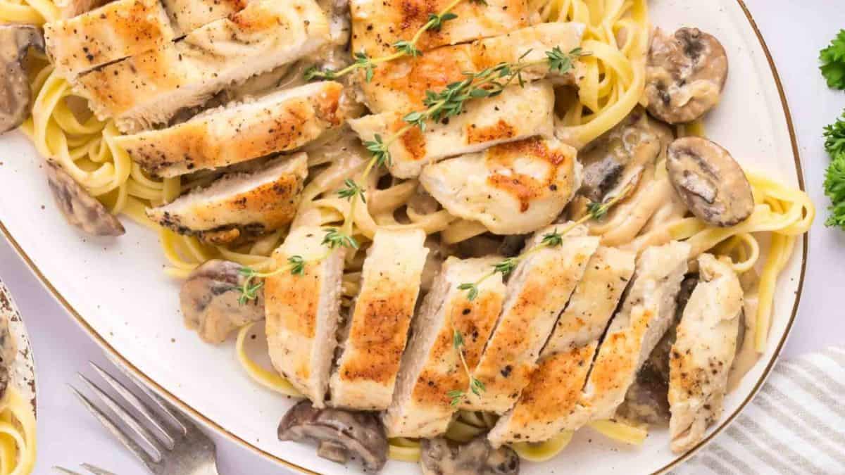 A top shot of a serving platter filled with Chicken Marsala Pasta. 