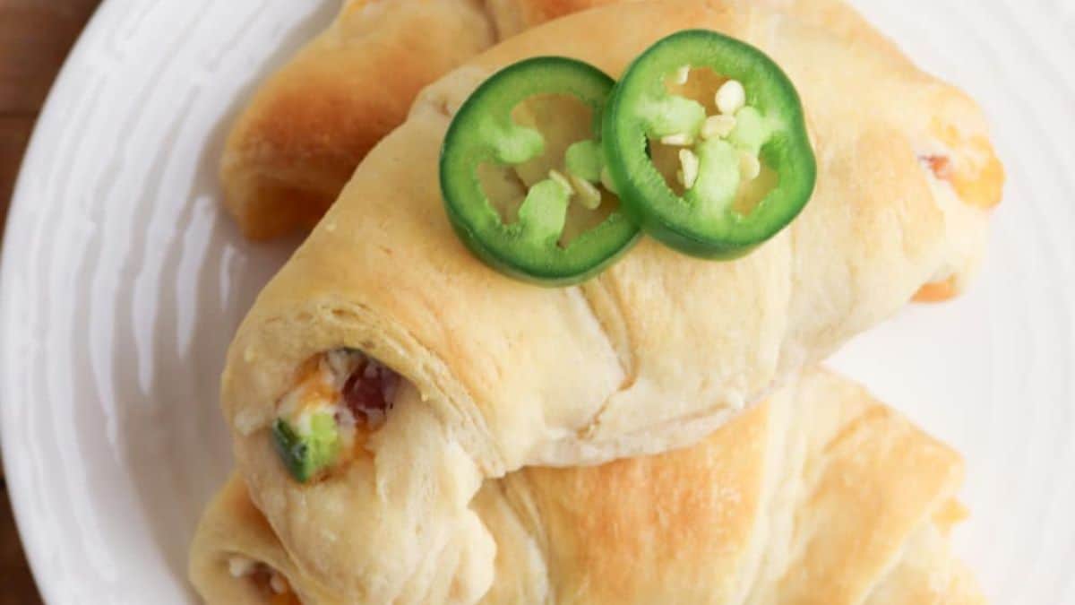 A close-up shot of Crescent Roll Jalapeño Poopers served on a plate.