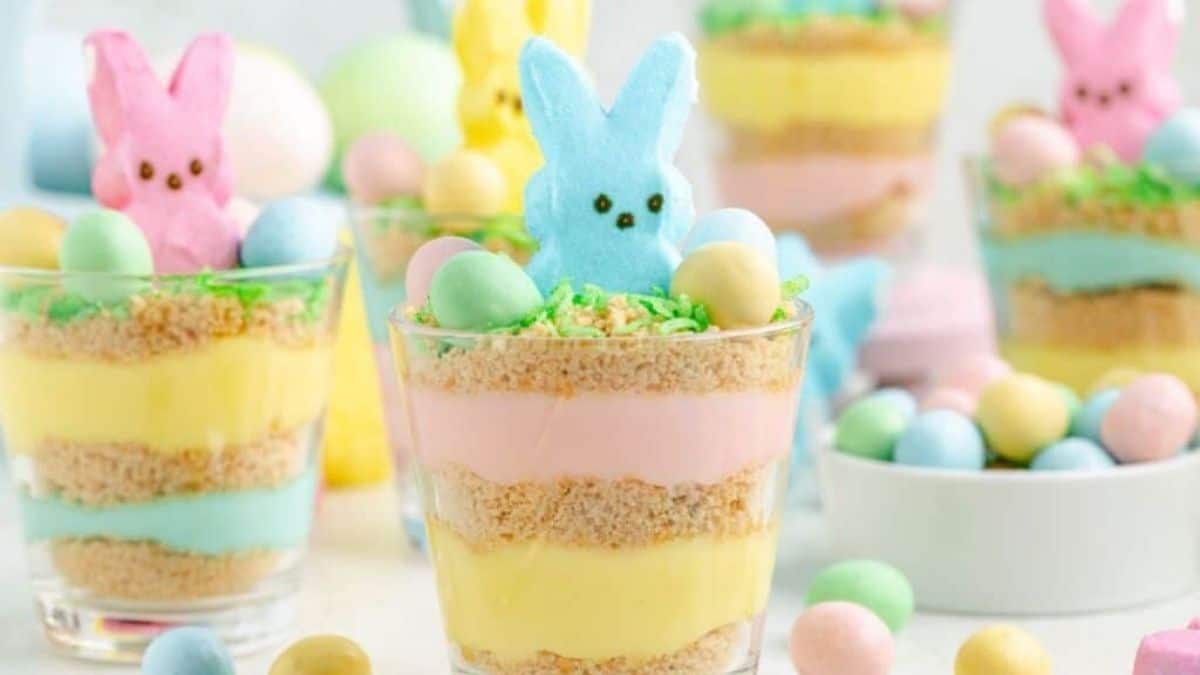 A couple of easter themed-pudding cups, all have layers of pudding, and topped with peeps bunny on each pf the, 