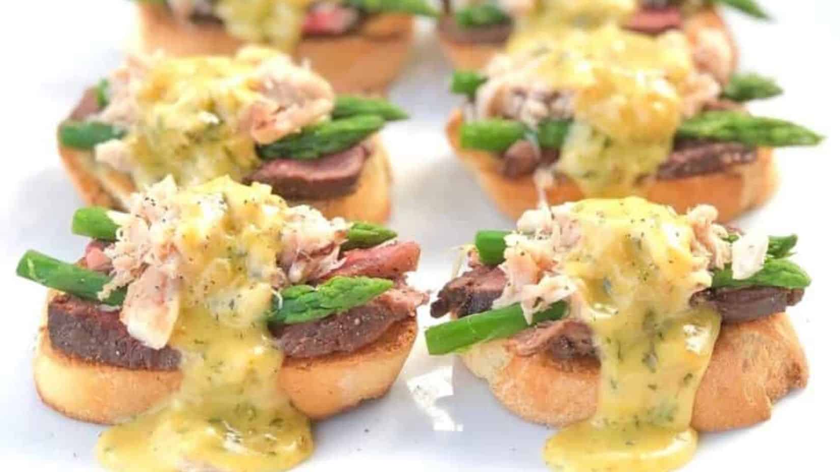 A close-up shot of a few pieces of filet Oscar crostini.