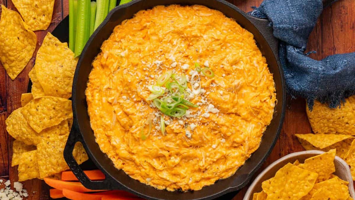 Top shot of a cast iron pan filled with buffalo dip. 