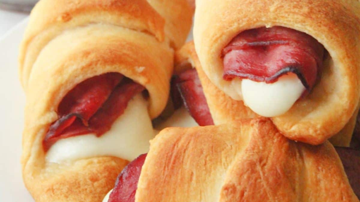 A close-up shot of French Dip Crescents piled together on a plate.