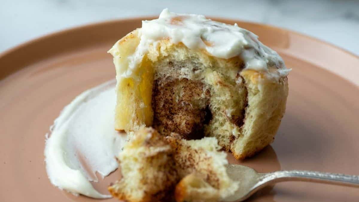 A cinnamon roll served on a plate. 