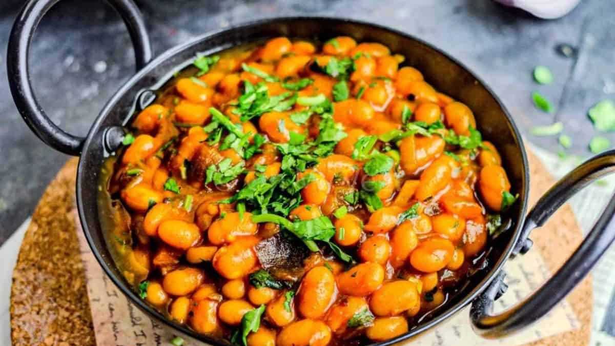 A close up shot of Masala Beans, baked Beans Curry on a small pot. 