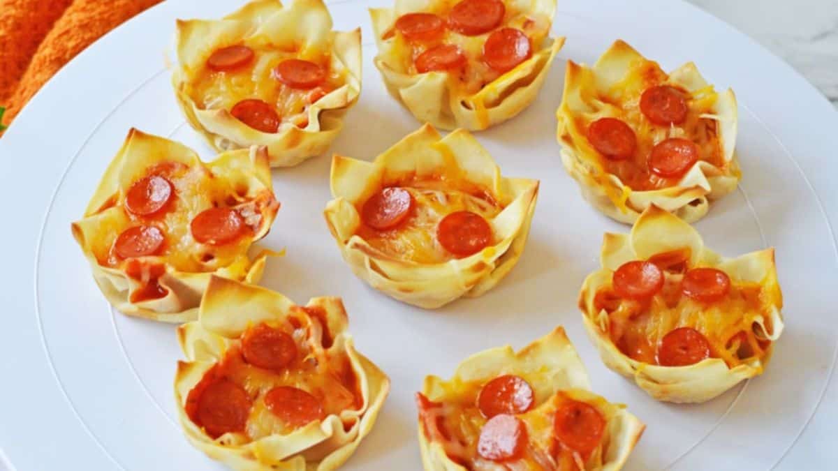A couple of pieces of Pizza Wontons set on a plate. 