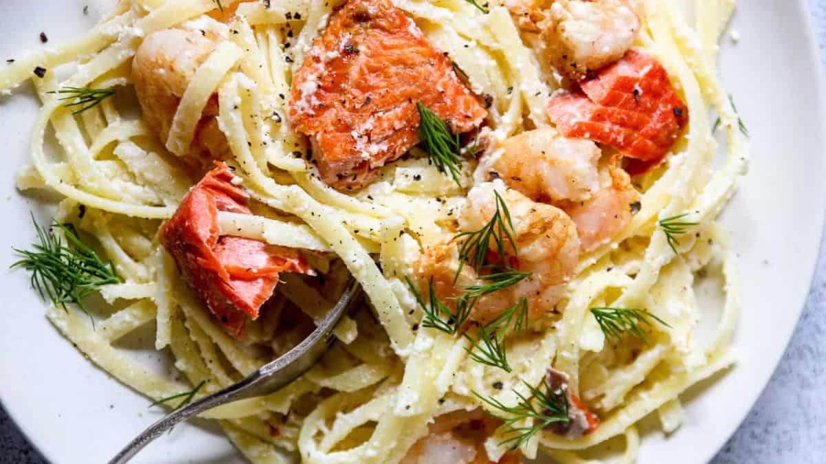 A plate of Shrimp and Salmon Alfredo.