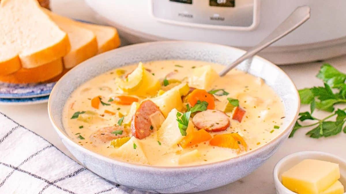 A bowl of Kielbasa Potato Soup with a spoon. 