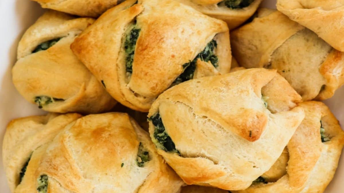 A close-up shot of couple of pieces of Spinach Cheese Crescent Rolls.