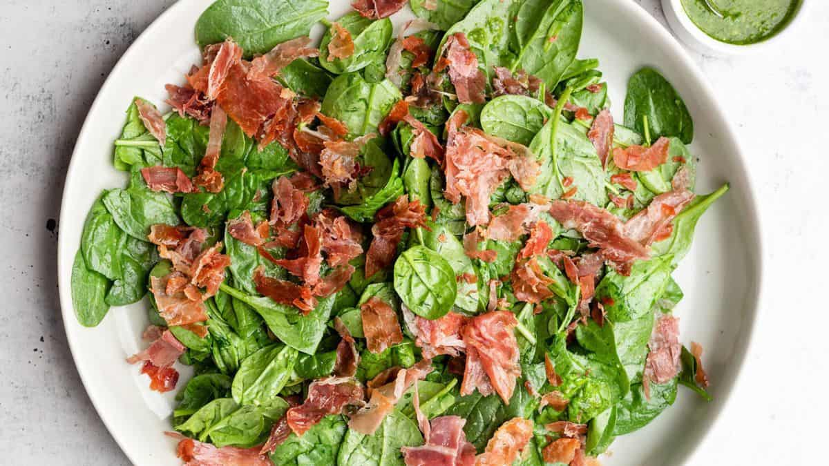 A top shot of a plateful of Spinach and Prosciutto Salad.