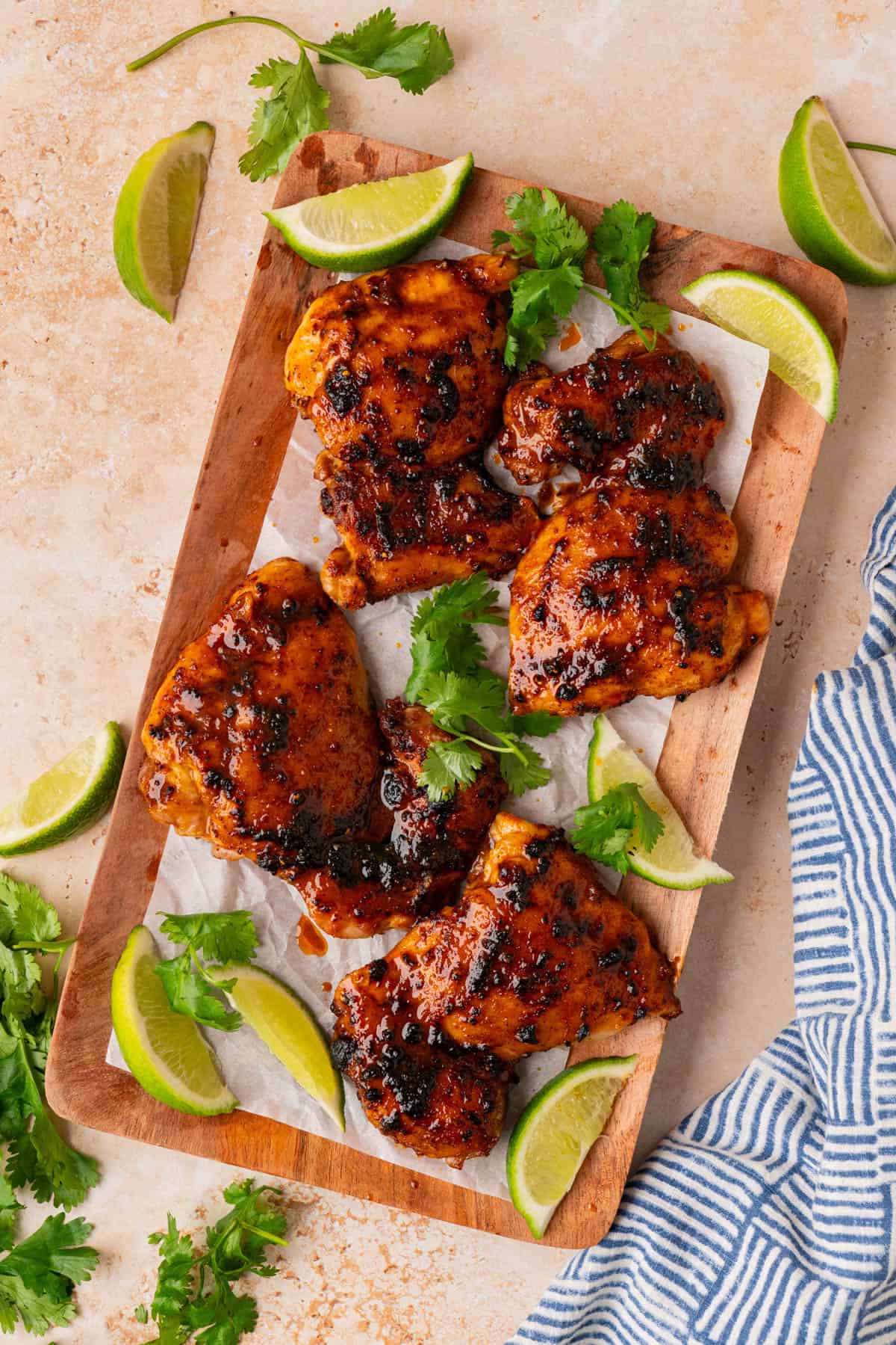 Overhead shot of the chicken thighs on a wooden cutting board.