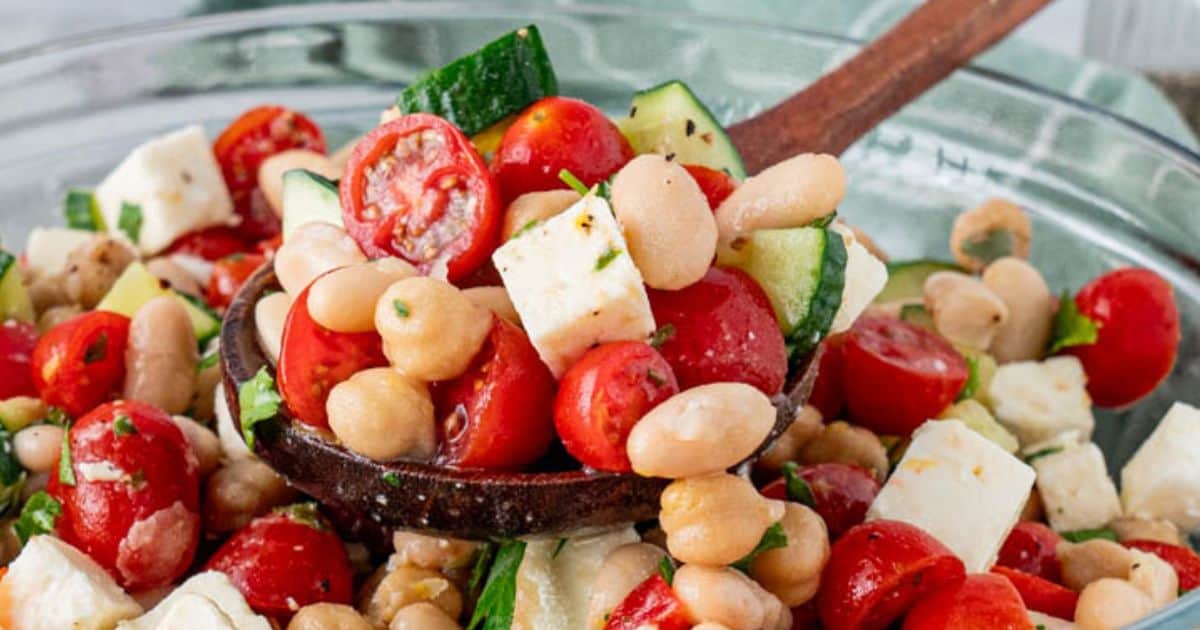 A spoonful of Mediterranean bean served on a clear bowl.