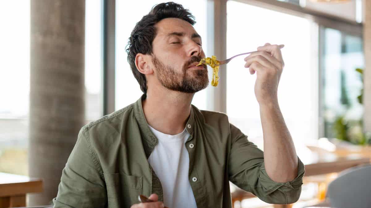 man eating pasta