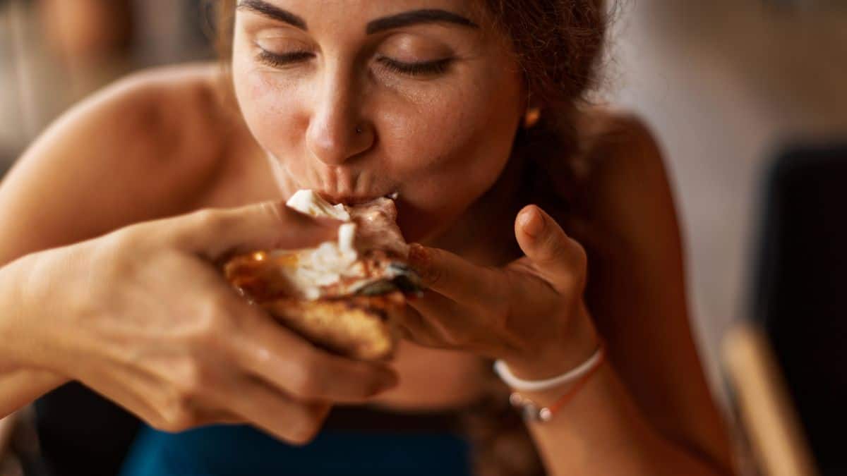 woman eating pizza