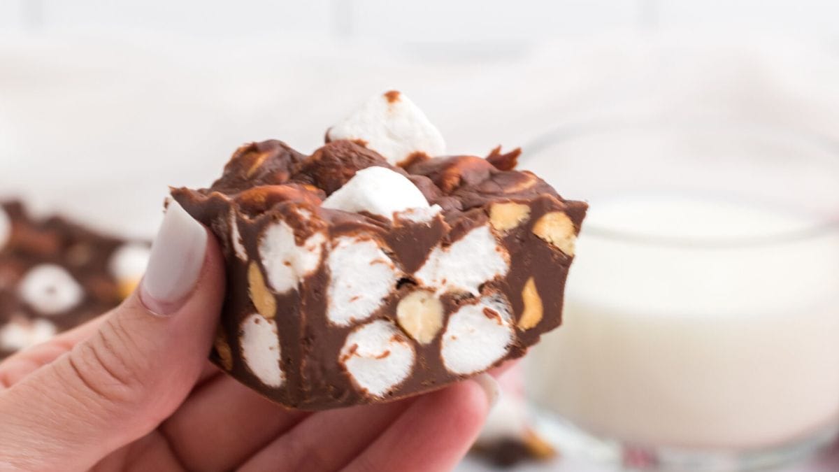 A piece of rocky road brownies being held