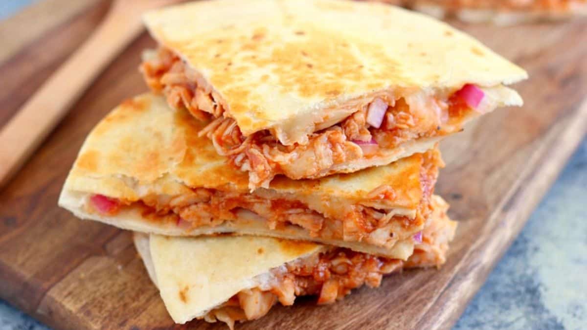 A close-up shot of a three-tier stack of BBQ Chicken Quesadilla.