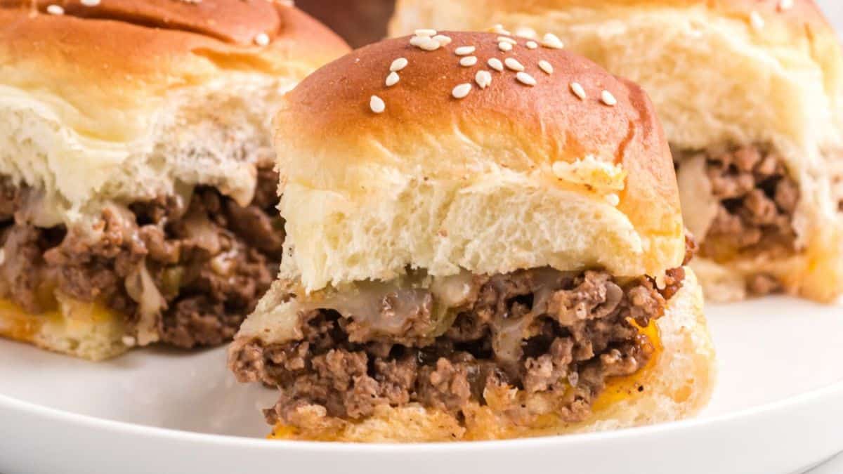 Mini cheeseburger sliders with beef patties, melted cheese and buns.