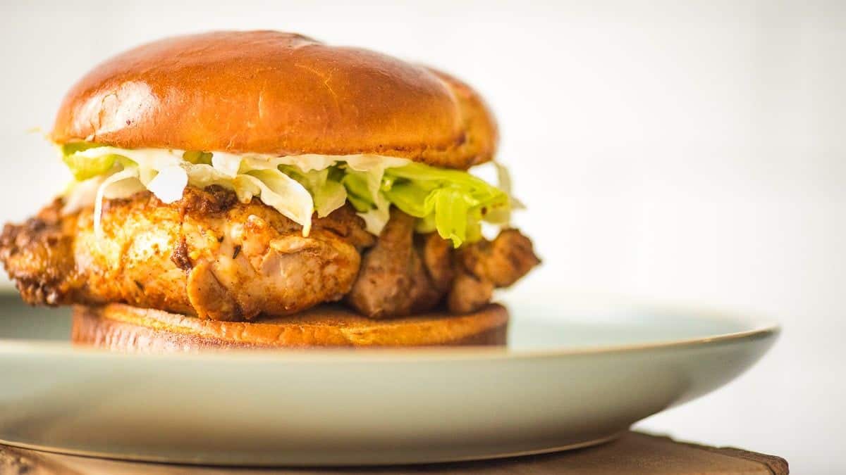 A shot of a blackened sandwich on a plate. 