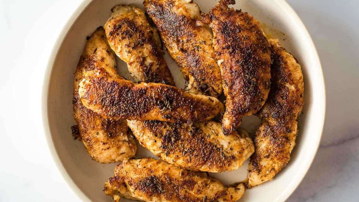 A plate of blackened chicken tenders. 