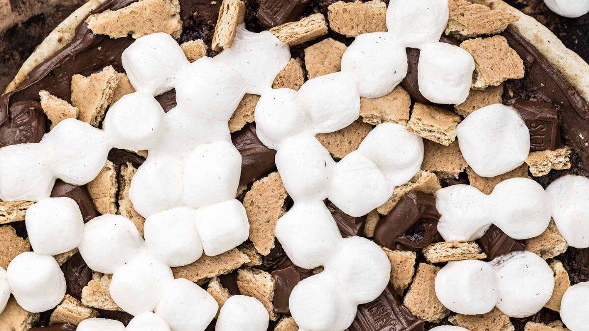 A close-up shot of pizza smores cooked in a campfire.