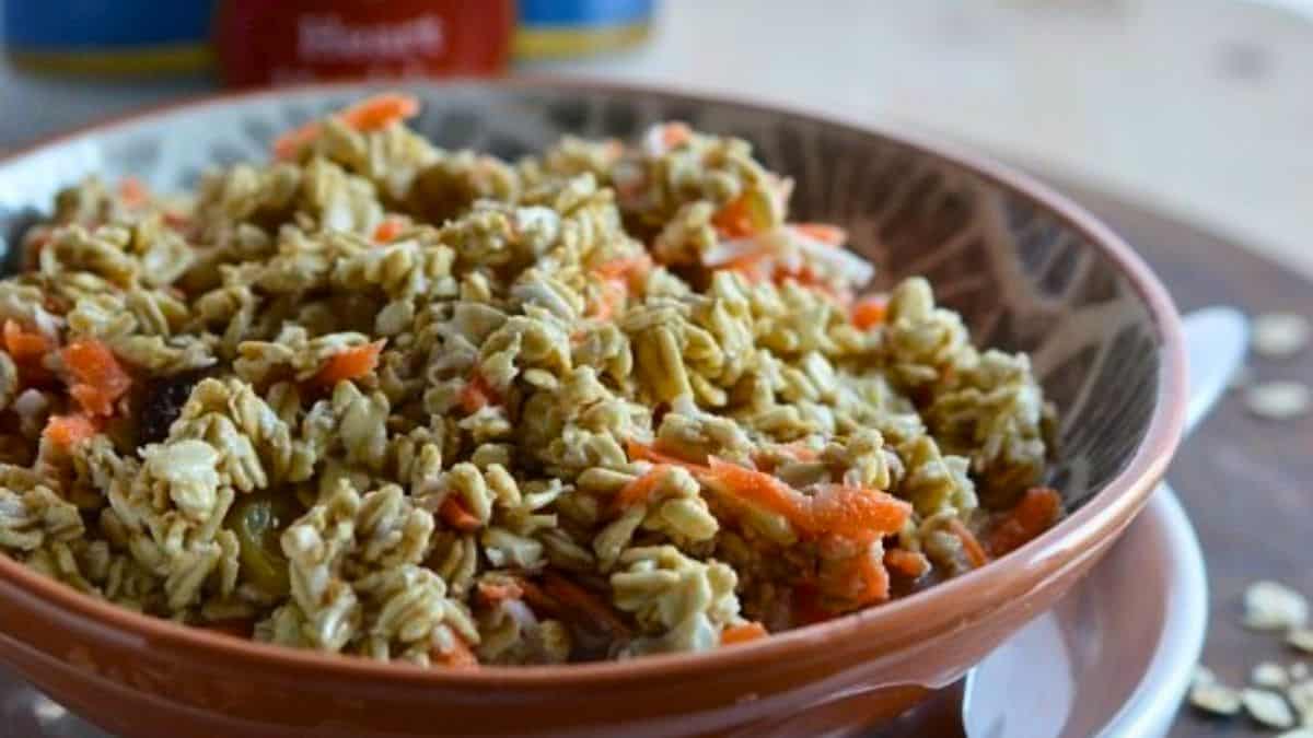 Carrot cake overnight oats with grated carrots, raisins and cinnamon in a jar.