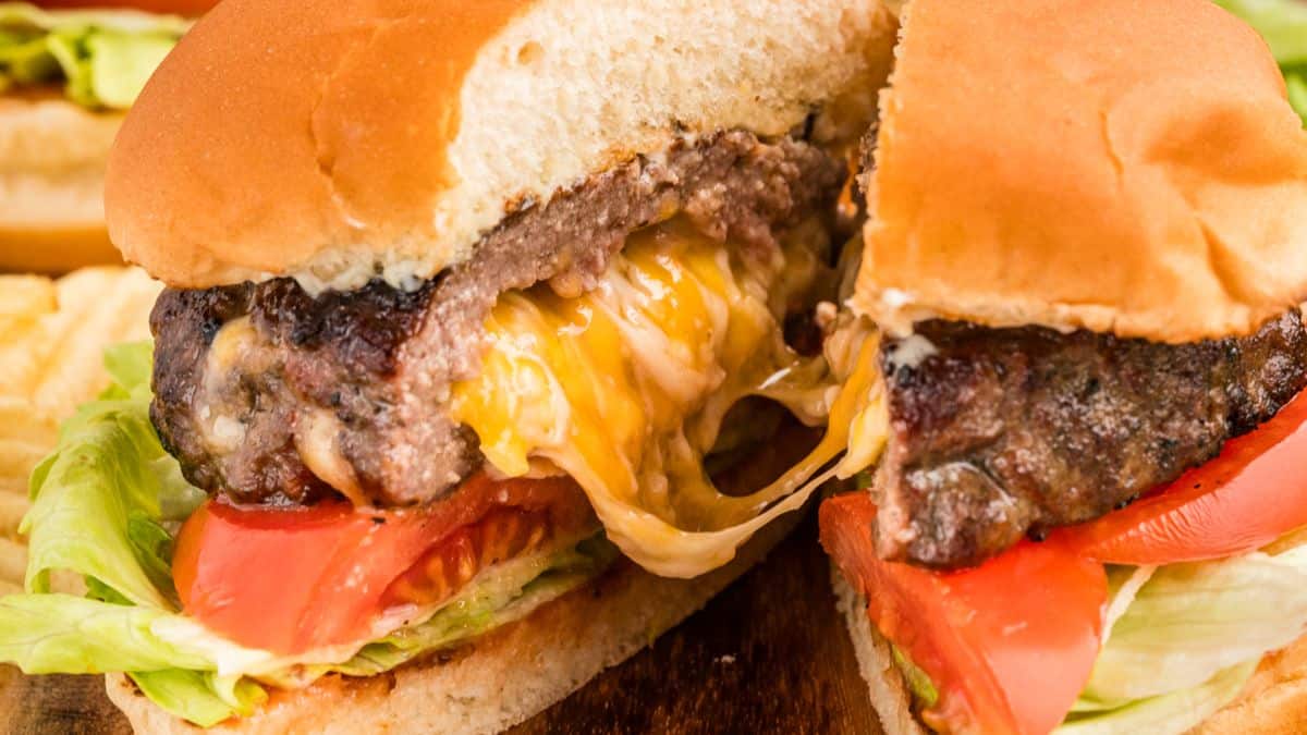 A close-up shot of a burger sliced in the middle. 
