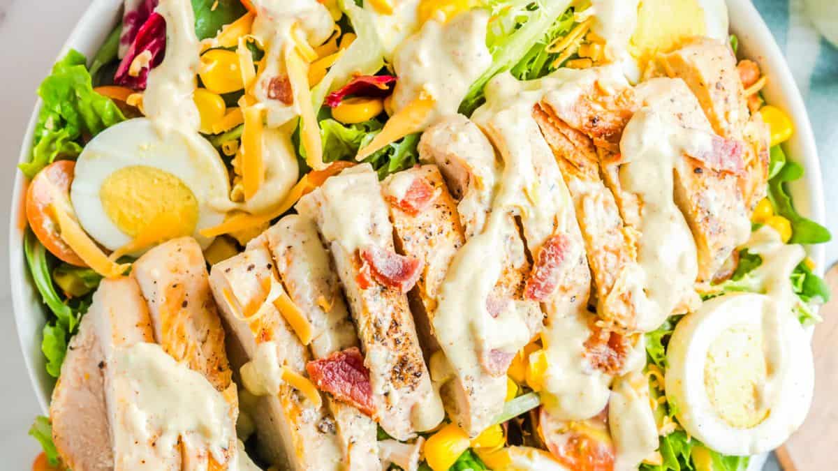 Cobb salad with chicken, eggs, bacon, avocado and greens.