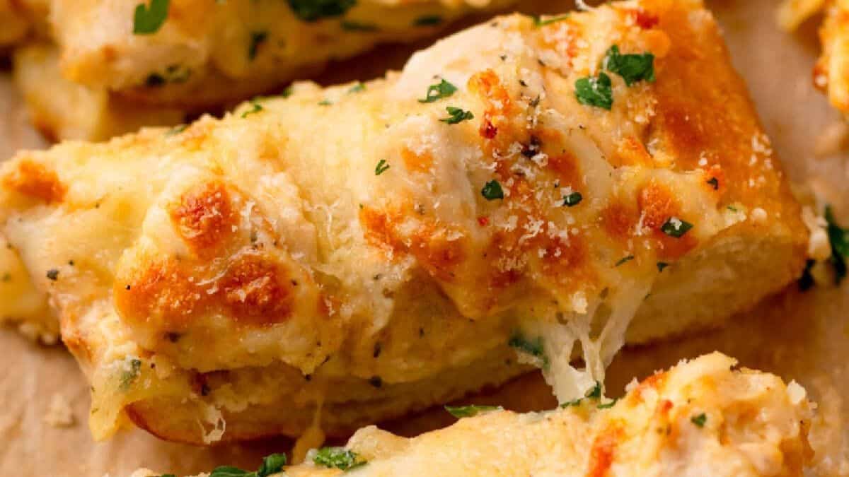 A close-up shot of a piece of garlic bread.