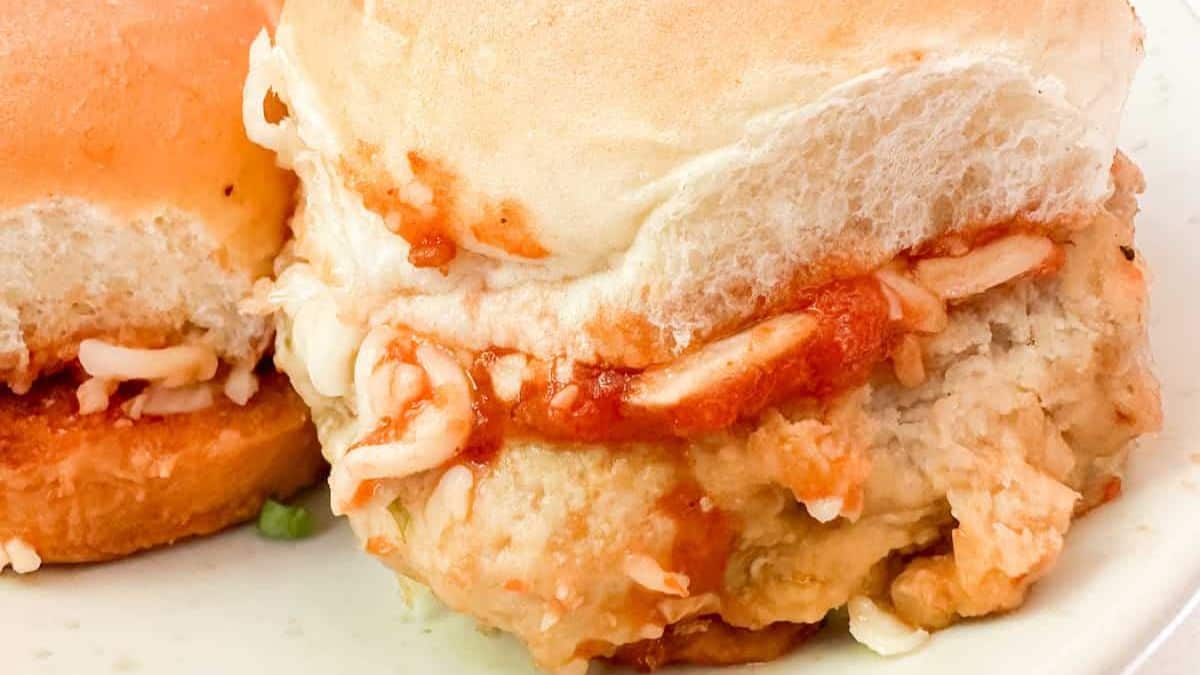 Chicken Parmesan sliders with breaded chicken, marinara and melted cheese on mini buns.