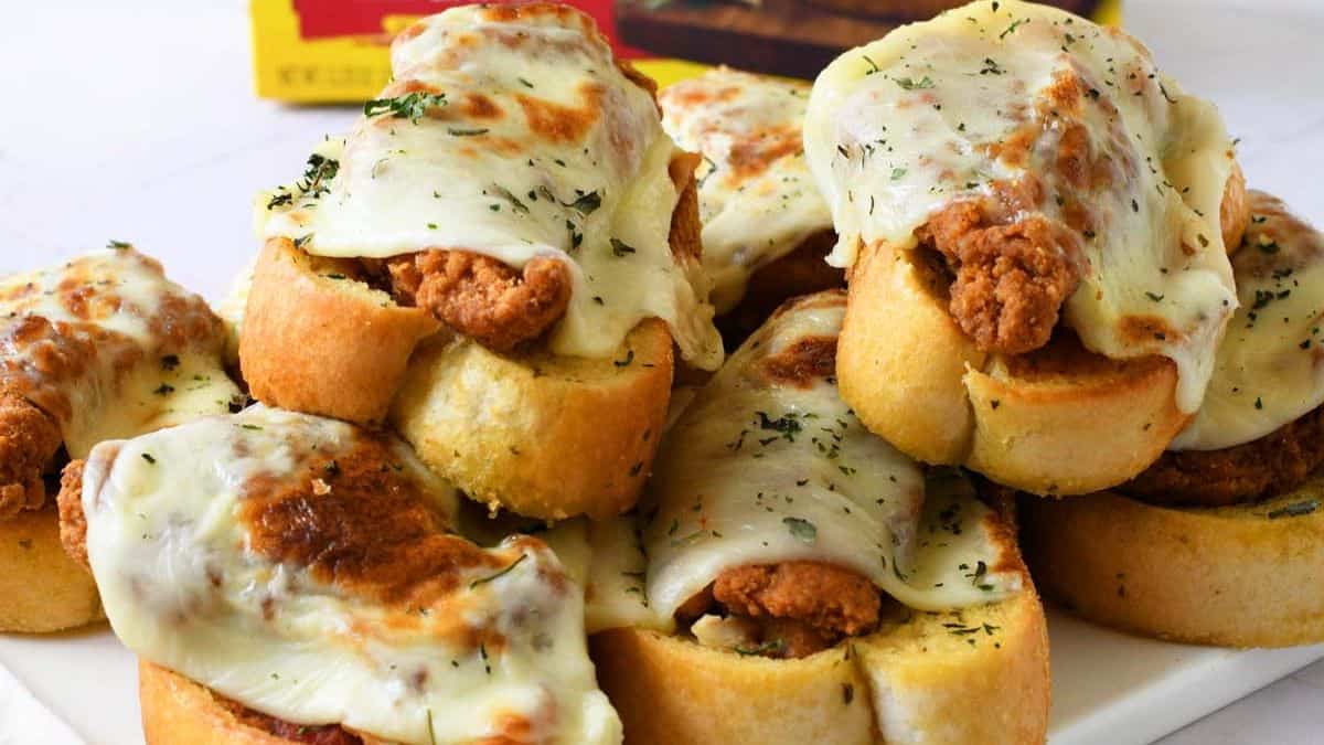 A couple of pieces of Chicken parmesan Texas Toasts served on a plate.