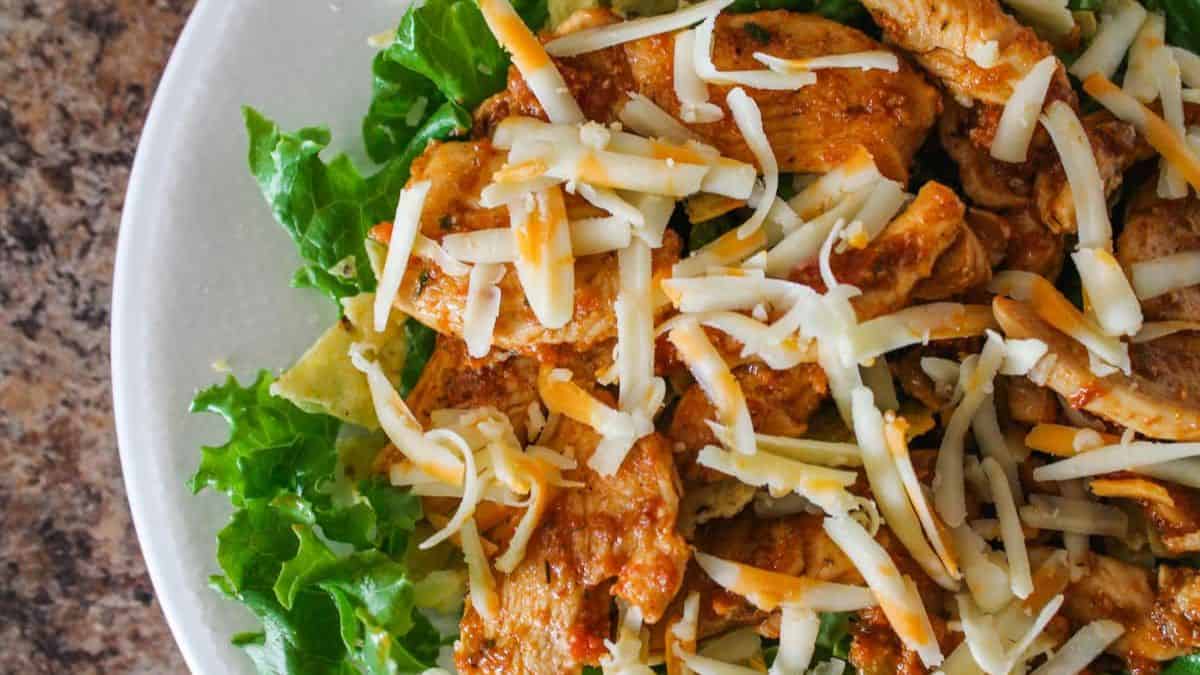 Easy gluten-free chicken taco salad with seasoned chicken and fresh toppings.