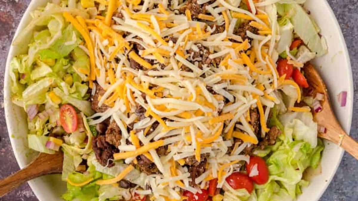 Classic taco salad with seasoned beef, lettuce, cheese and crunchy tortilla chips.