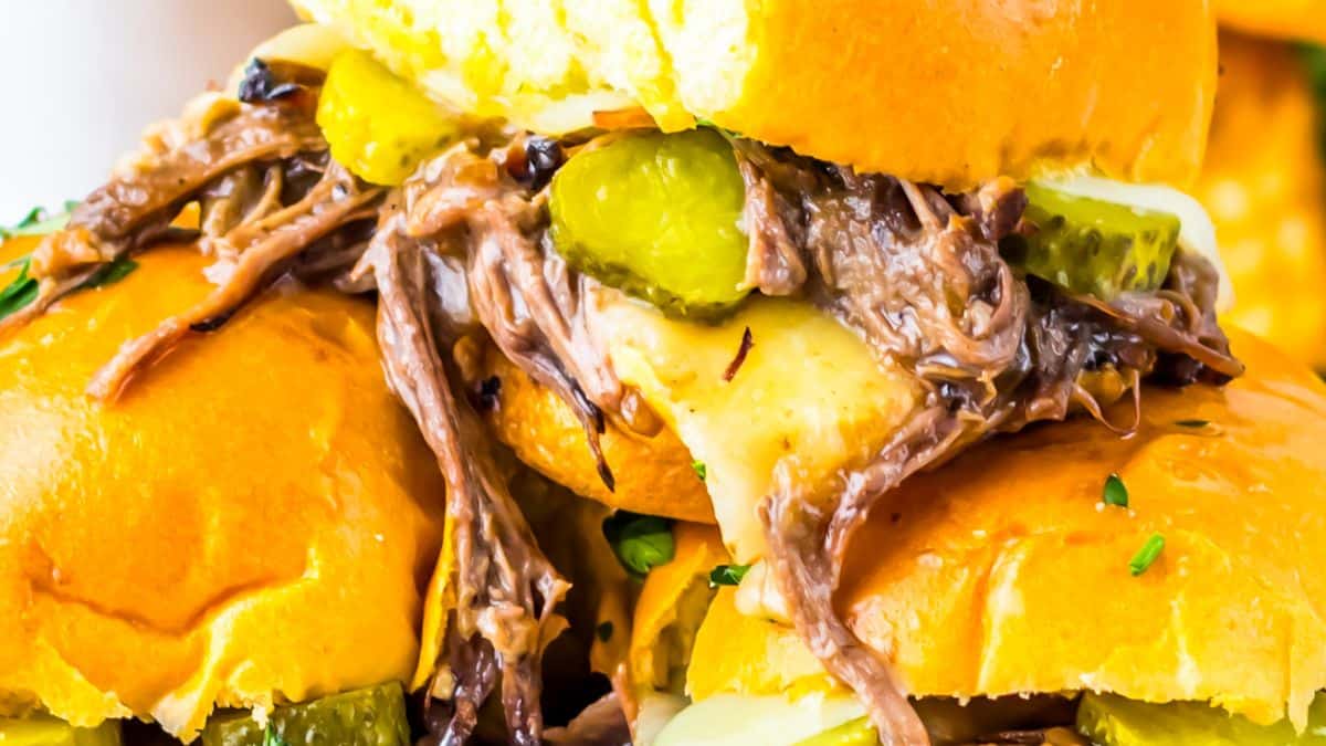 Slow‑cooker shredded beef sliders piled high on soft buns.