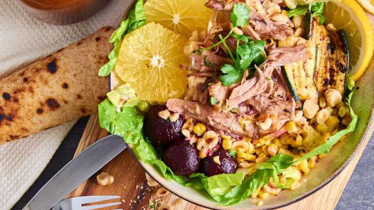Cuban pulled pork salad with shredded pork and mixed salad greens.