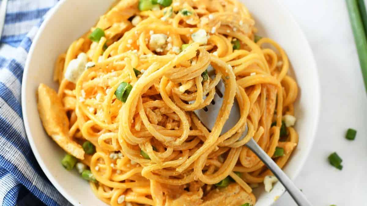 Buffalo chicken spaghetti with creamy spicy sauce and shredded chicken.
