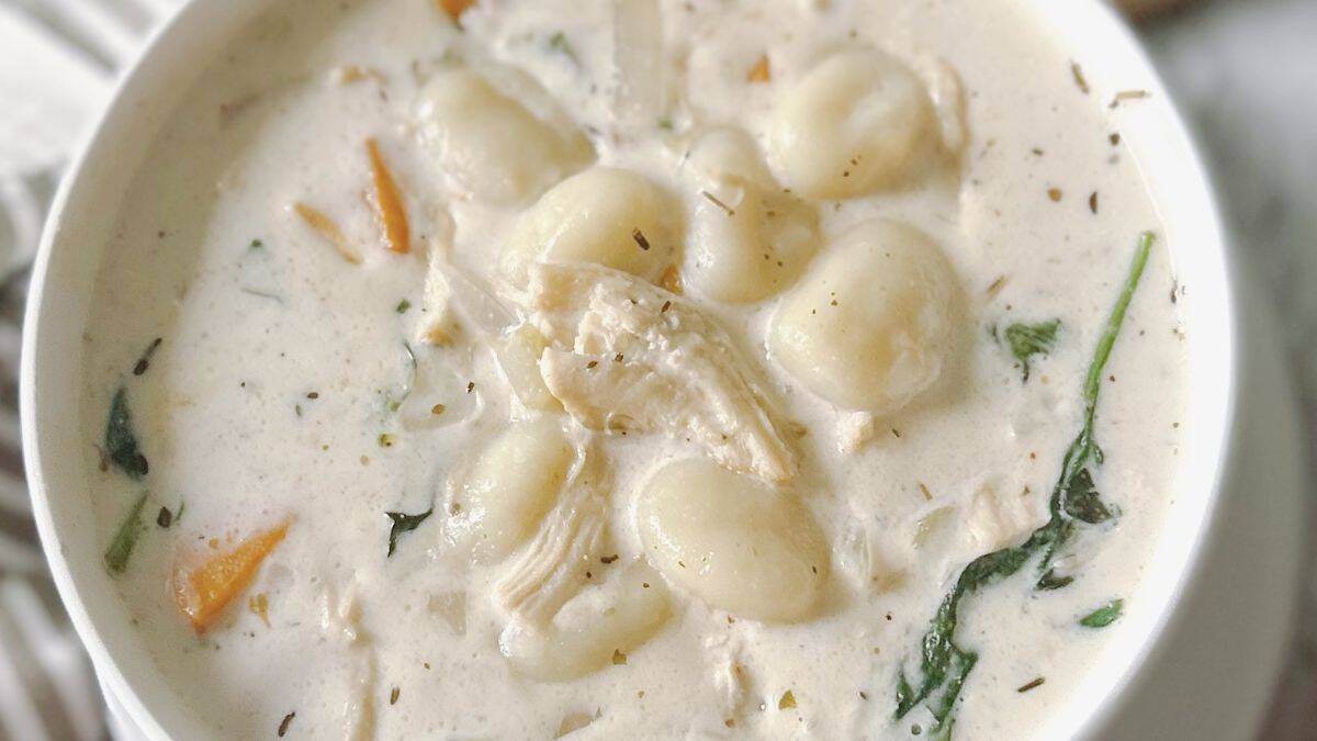 A close-up shot of a bowl filled with chicken gnocchi soup.