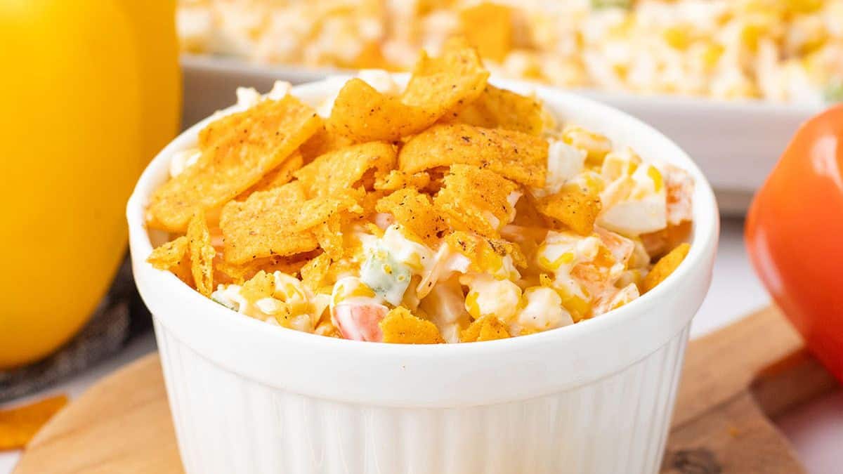 A ramekin filled with Frito corn salad. 