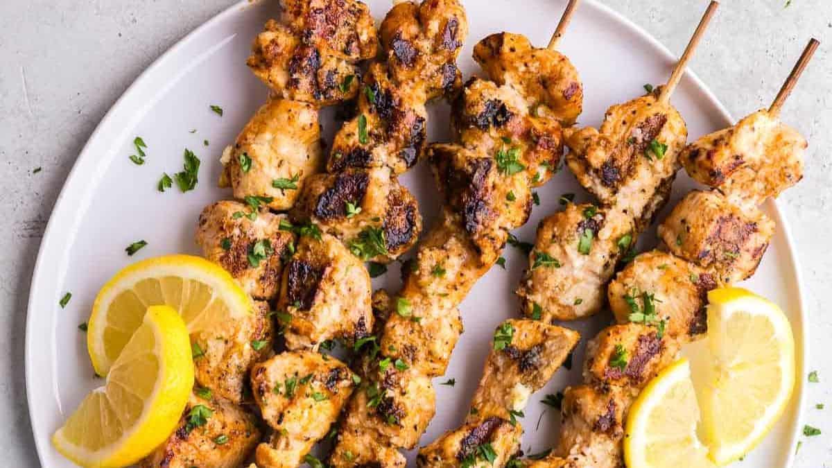 Garlic parmesan chicken skewers with herbs and grated parmesan.
