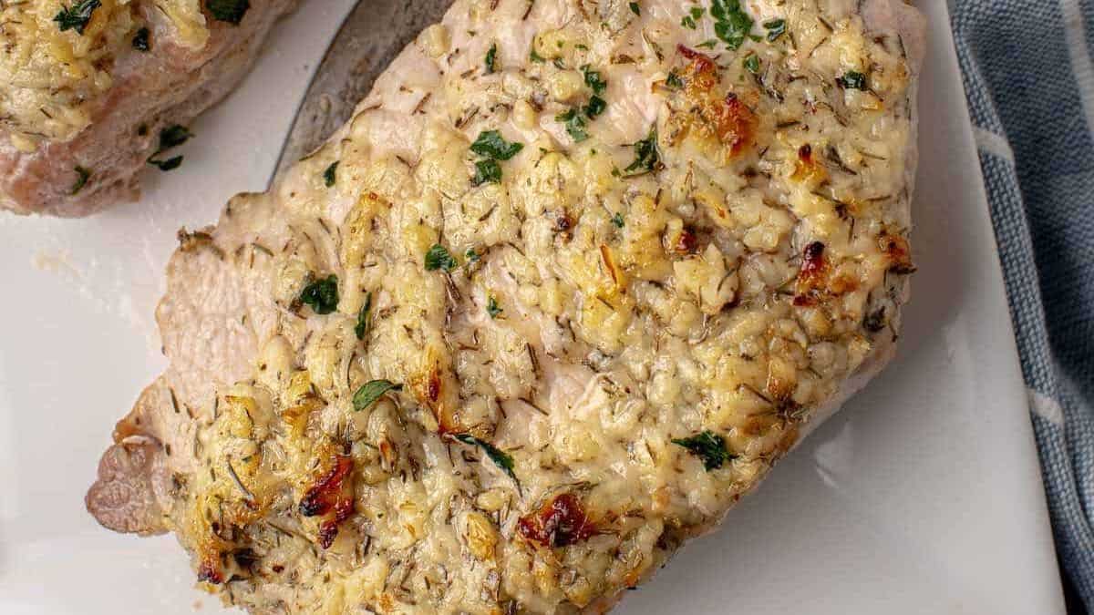 A close up shot of a single piece of garlic parmesan porkchop.
