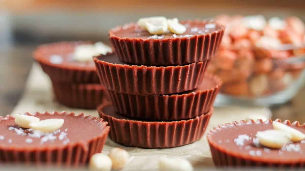 In the center can be found four-tier stack of homemade peanut bitter cups and some other blurry  on the side and on the back. 